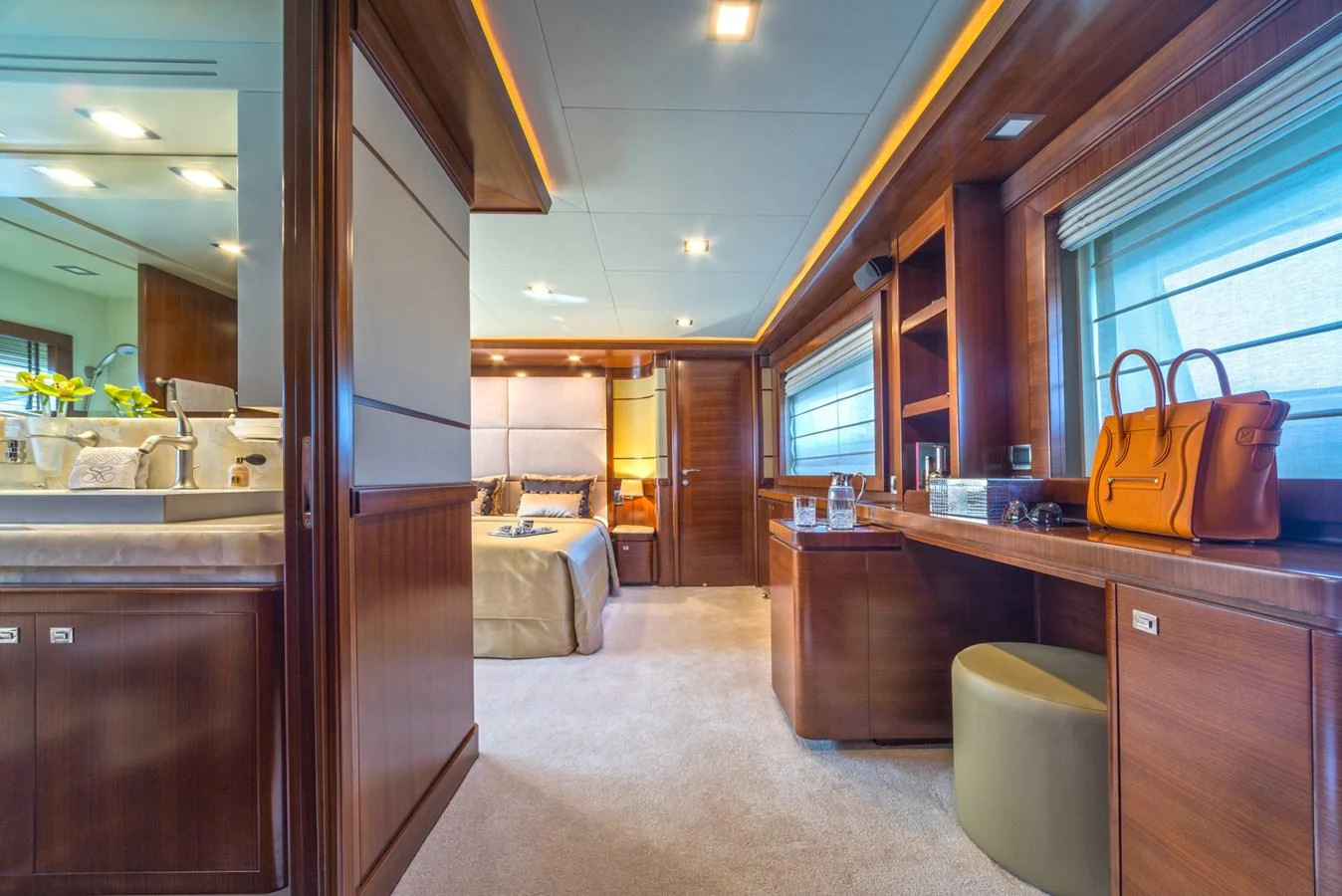 The master stateroom features luxurious wood finishes, a spacious layout, and elegant decor. aboard SEVENTH SENSE Yacht for Sale