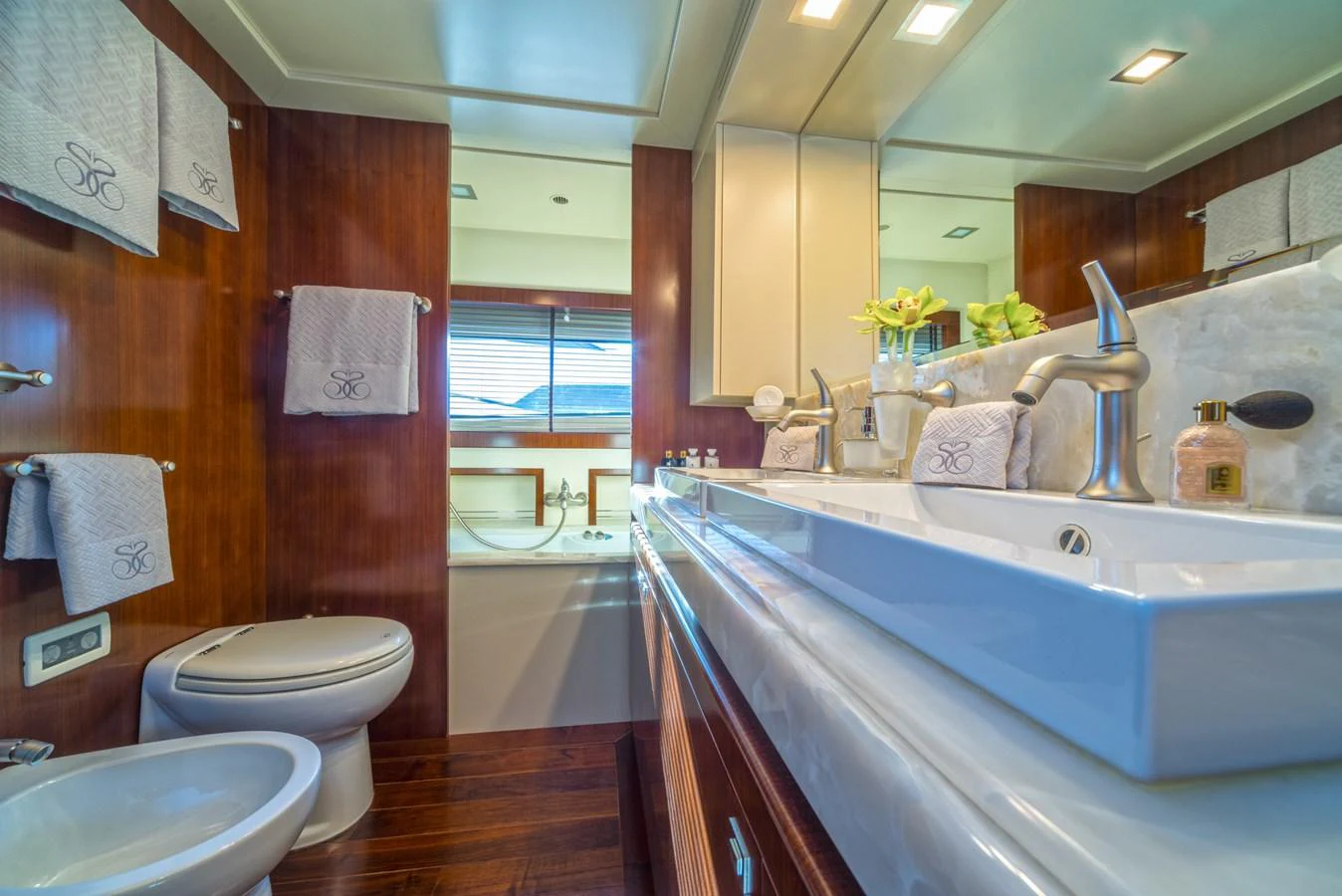 The yacht's bathroom features elegant fixtures and a luxurious design with ample natural light. aboard SEVENTH SENSE Yacht for Sale