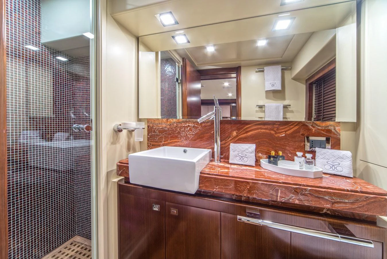 The yacht's bathroom features a modern sink, luxurious marble countertop, and elegant fixtures. aboard SEVENTH SENSE Yacht for Sale