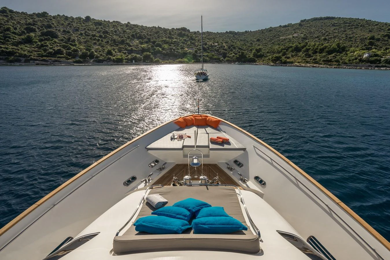 The foredeck of the yacht offers a serene view of the water with comfortable sun pads and a picturesque backdrop. aboard SEVENTH SENSE Yacht for Sale