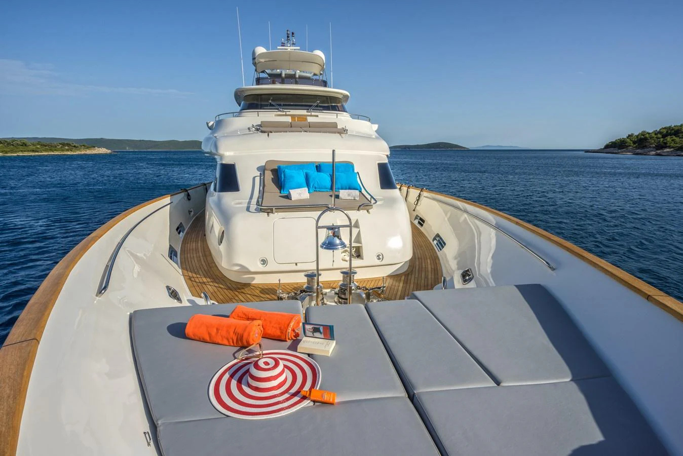 The foredeck of this yacht offers a luxurious sunbathing area with comfortable cushions and scenic views. aboard SEVENTH SENSE Yacht for Sale