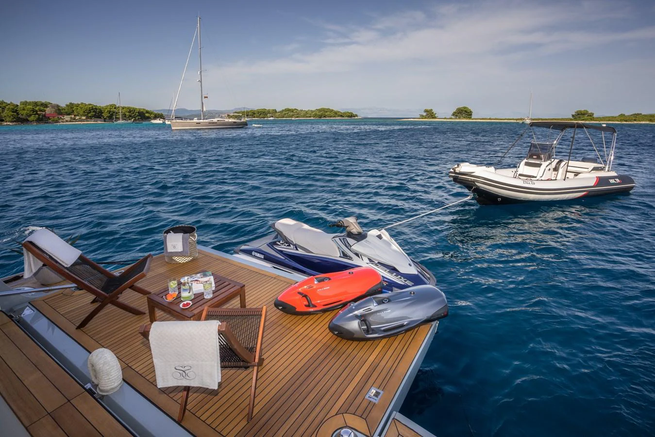 The swim platform is equipped with comfortable seating and various water toys, offering a perfect spot for relaxation and adventure. aboard SEVENTH SENSE Yacht for Sale