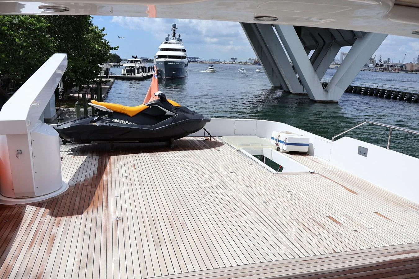 The aft deck features a spacious area with a jet ski and a view of the surrounding marina. aboard Q Yacht for Sale