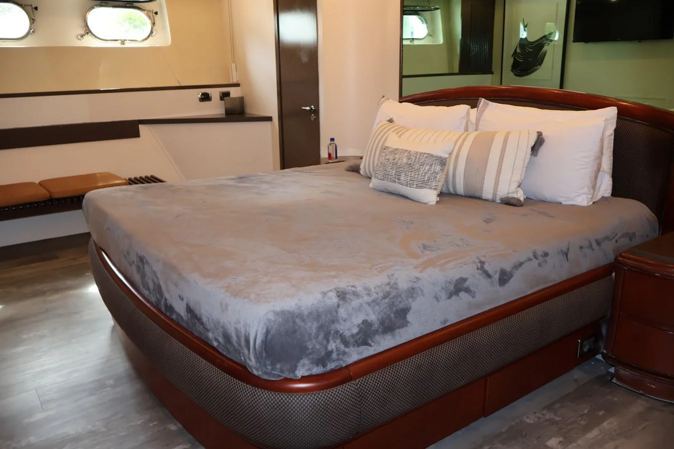 The stateroom features a plush bed with elegant bedding and ample natural light from the windows. aboard Q Yacht for Sale