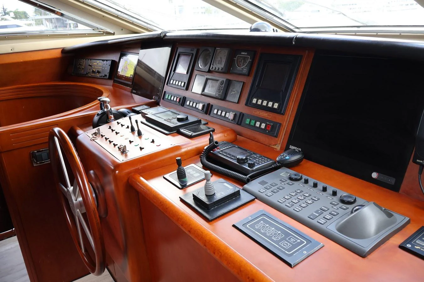 The helm station features advanced navigation equipment and luxurious wood finishes. aboard Q Yacht for Sale