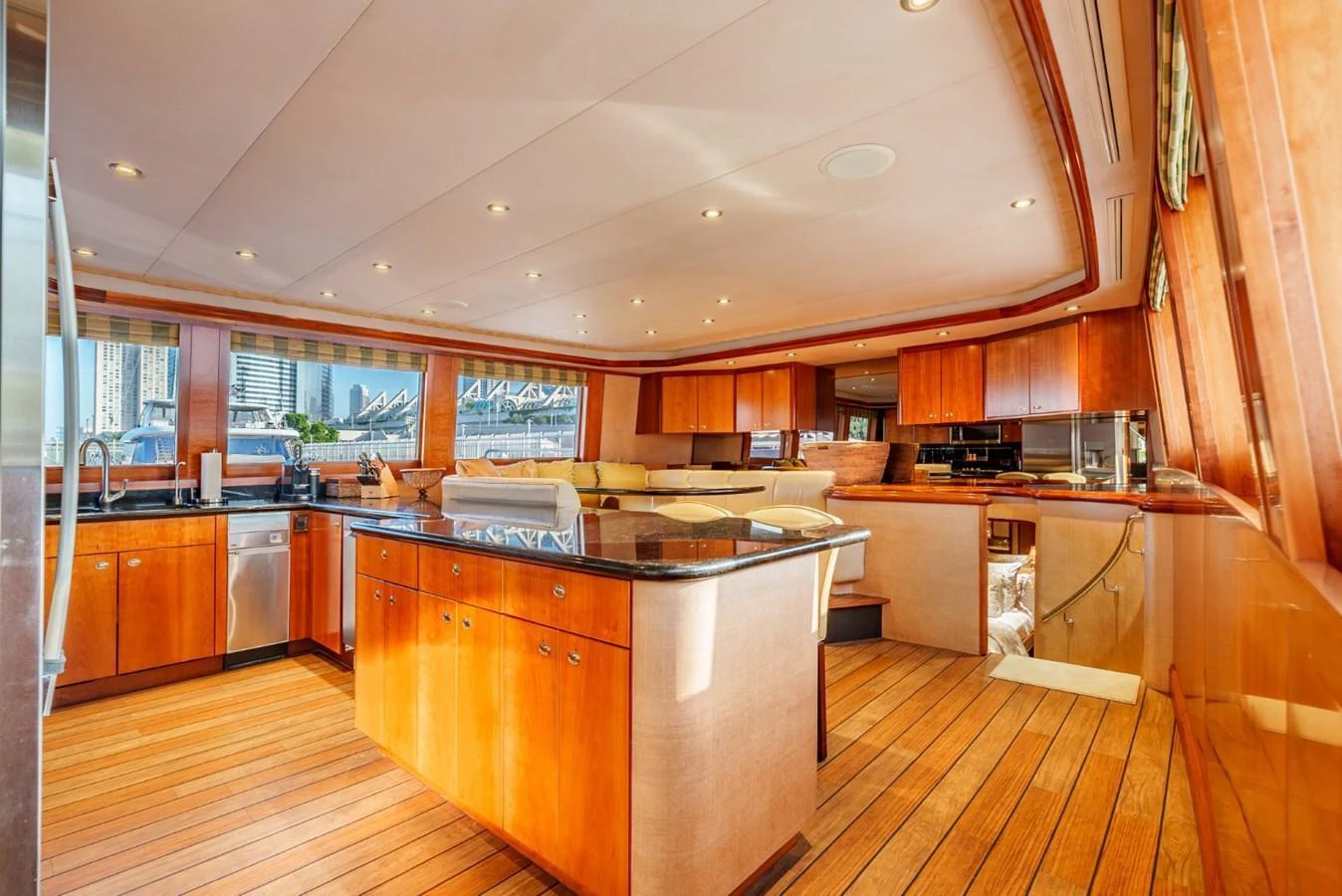 The galley features warm wood finishes, ample counter space, and modern appliances, creating a welcoming and functional space. aboard SNOWBORED Yacht for Sale
