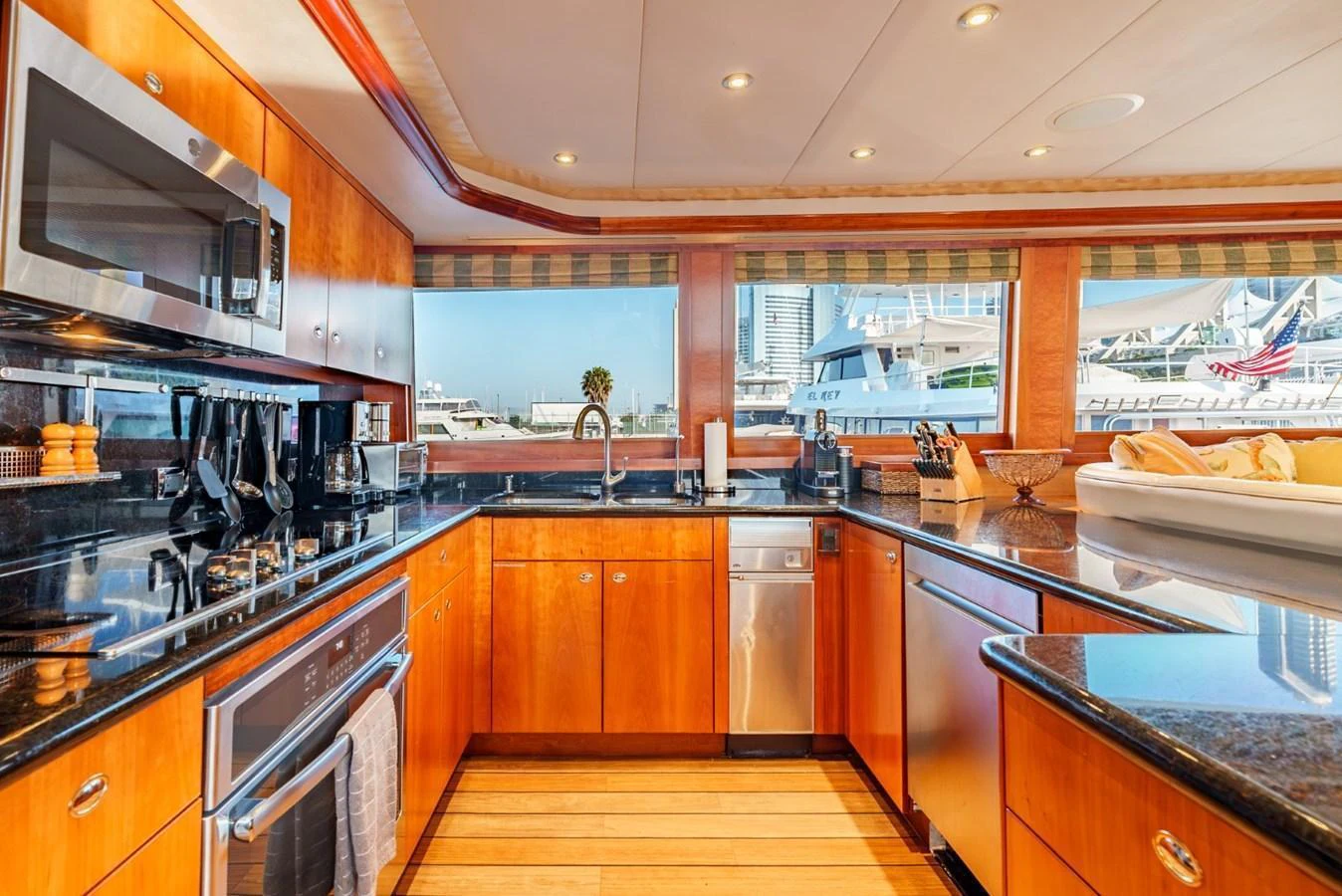 The yacht's galley features modern appliances and ample counter space with a view of the marina. aboard SNOWBORED Yacht for Sale