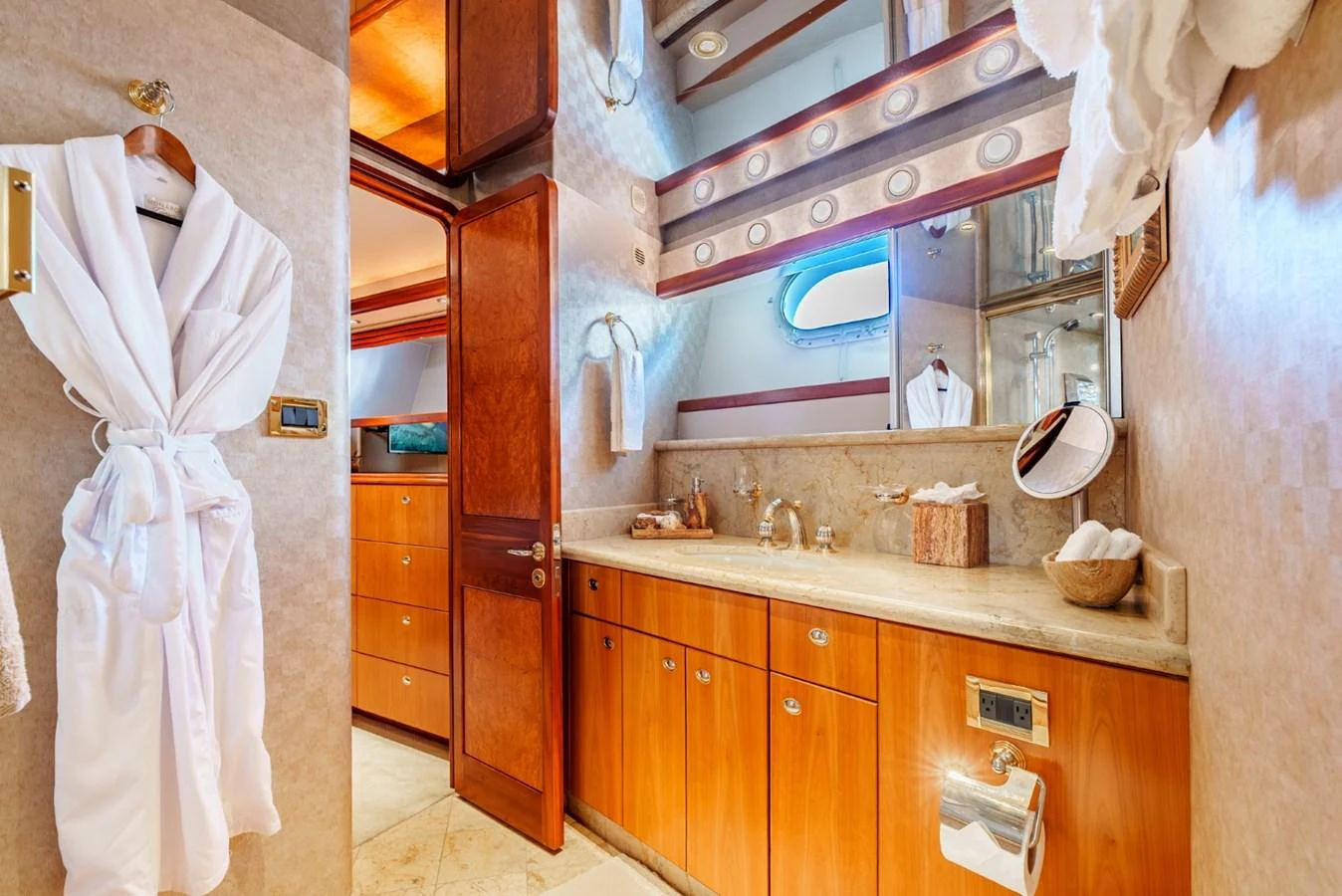 The yacht's bathroom features elegant wooden cabinetry and luxurious amenities. aboard SNOWBORED Yacht for Sale