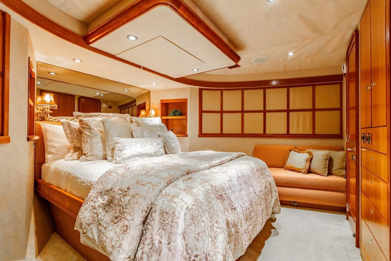 The master stateroom features a luxurious bed with plush bedding and elegant wood paneling. aboard SNOWBORED Yacht for Sale