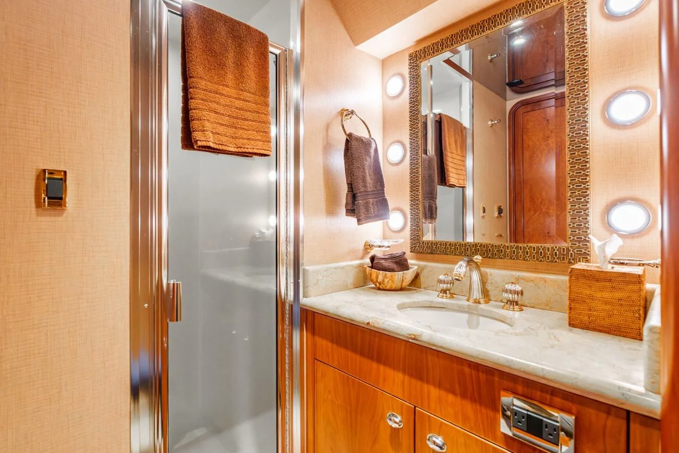 The yacht's bathroom features elegant fixtures and a well-lit vanity area. aboard SNOWBORED Yacht for Sale