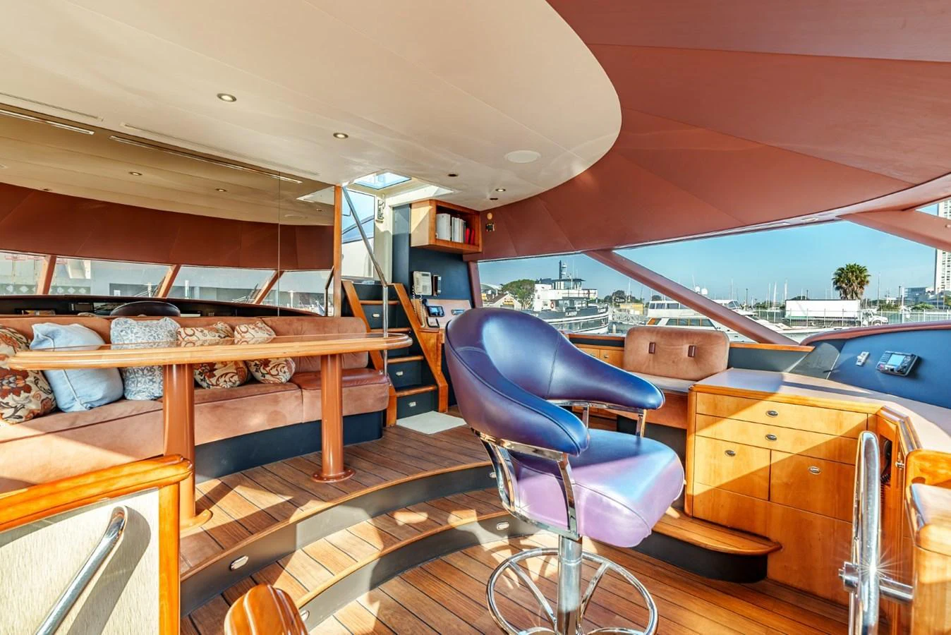 The helm area features luxurious seating and a well-equipped control station with a panoramic view. aboard SNOWBORED Yacht for Sale