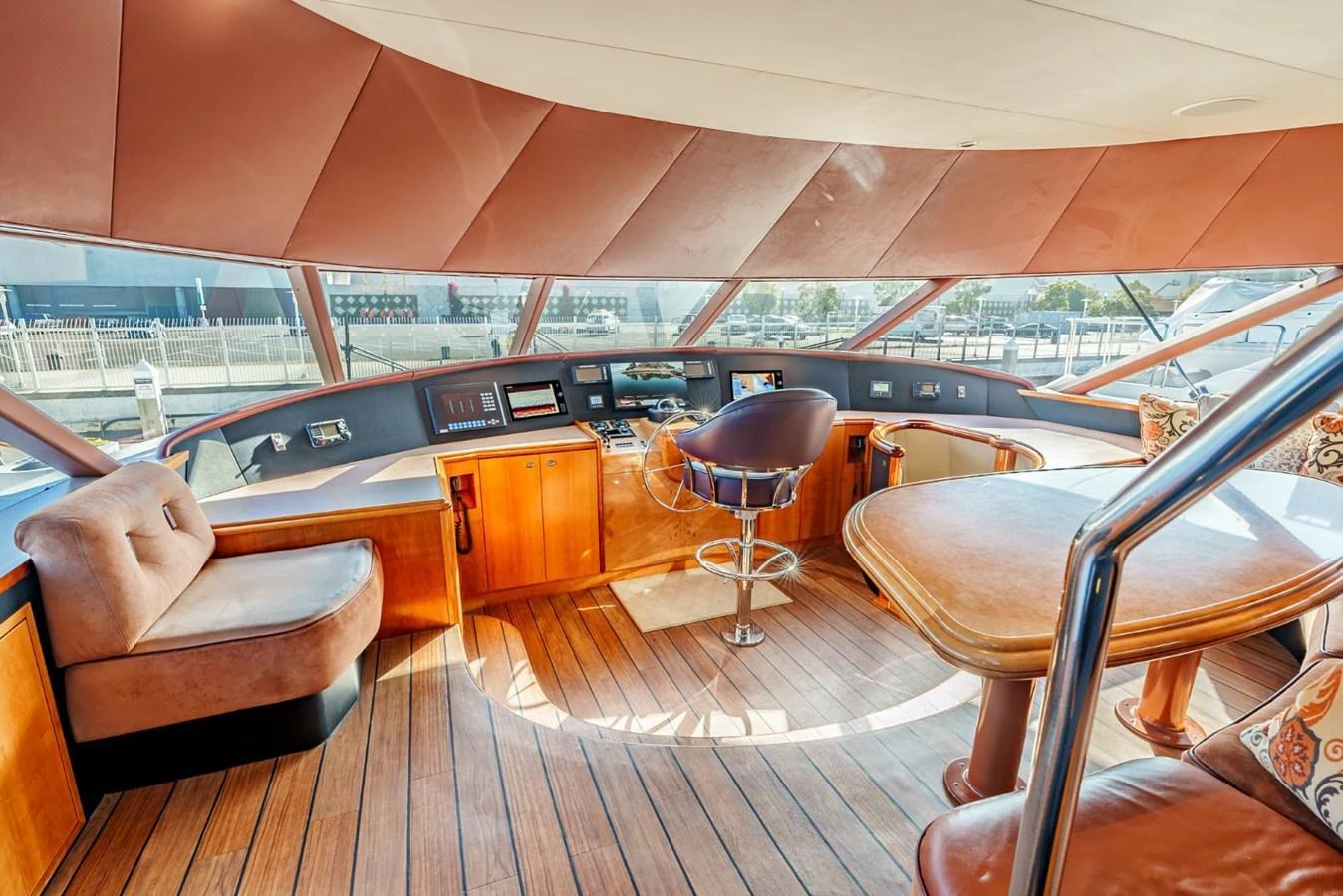 The helm area features a luxurious seating arrangement with a panoramic view. aboard SNOWBORED Yacht for Sale