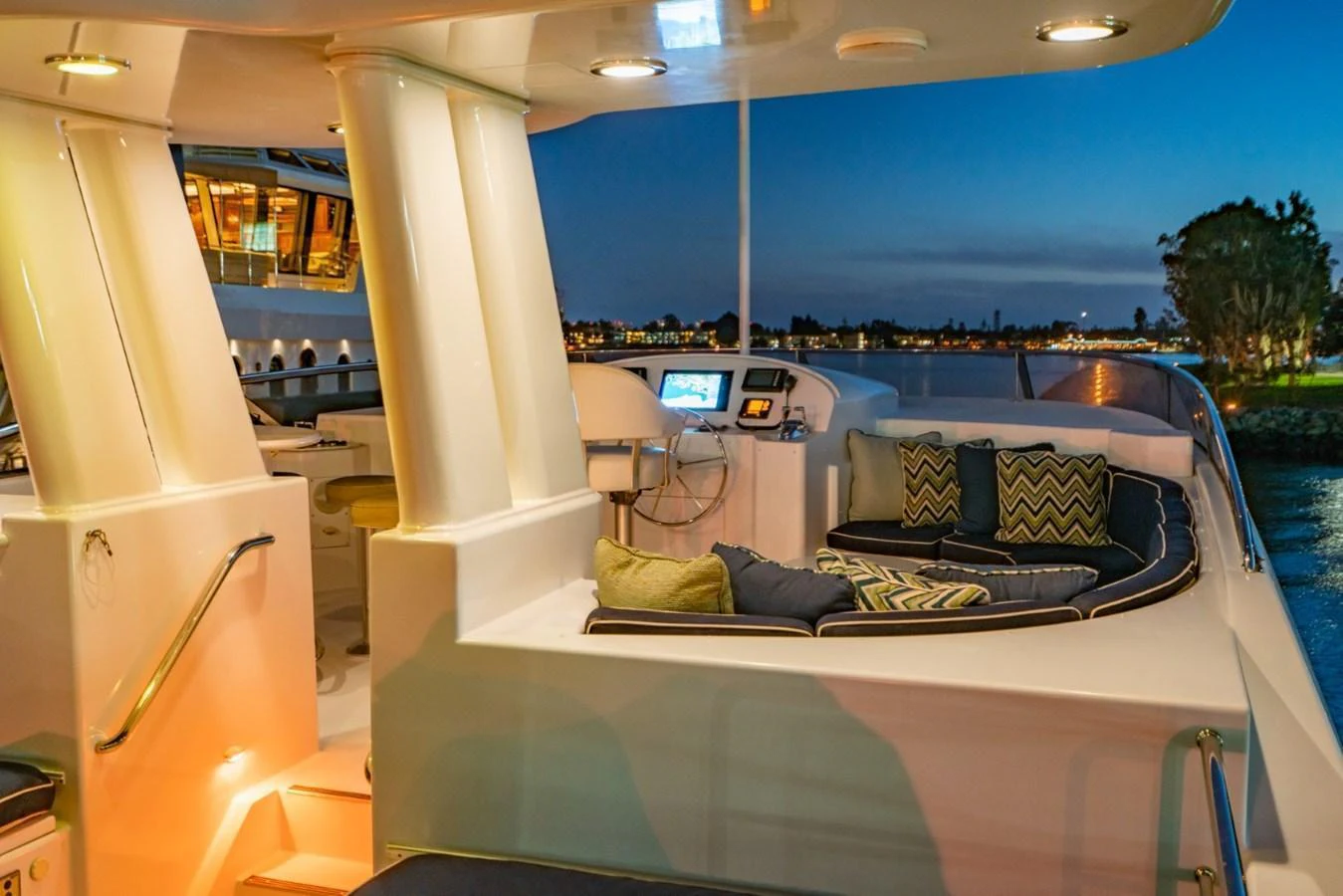 The aft deck offers a cozy seating area with plush cushions, perfect for enjoying the evening view. aboard SNOWBORED Yacht for Sale