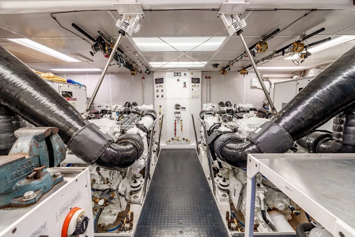 The yacht's engine room showcases powerful machinery and a clean, organized layout. aboard SNOWBORED Yacht for Sale