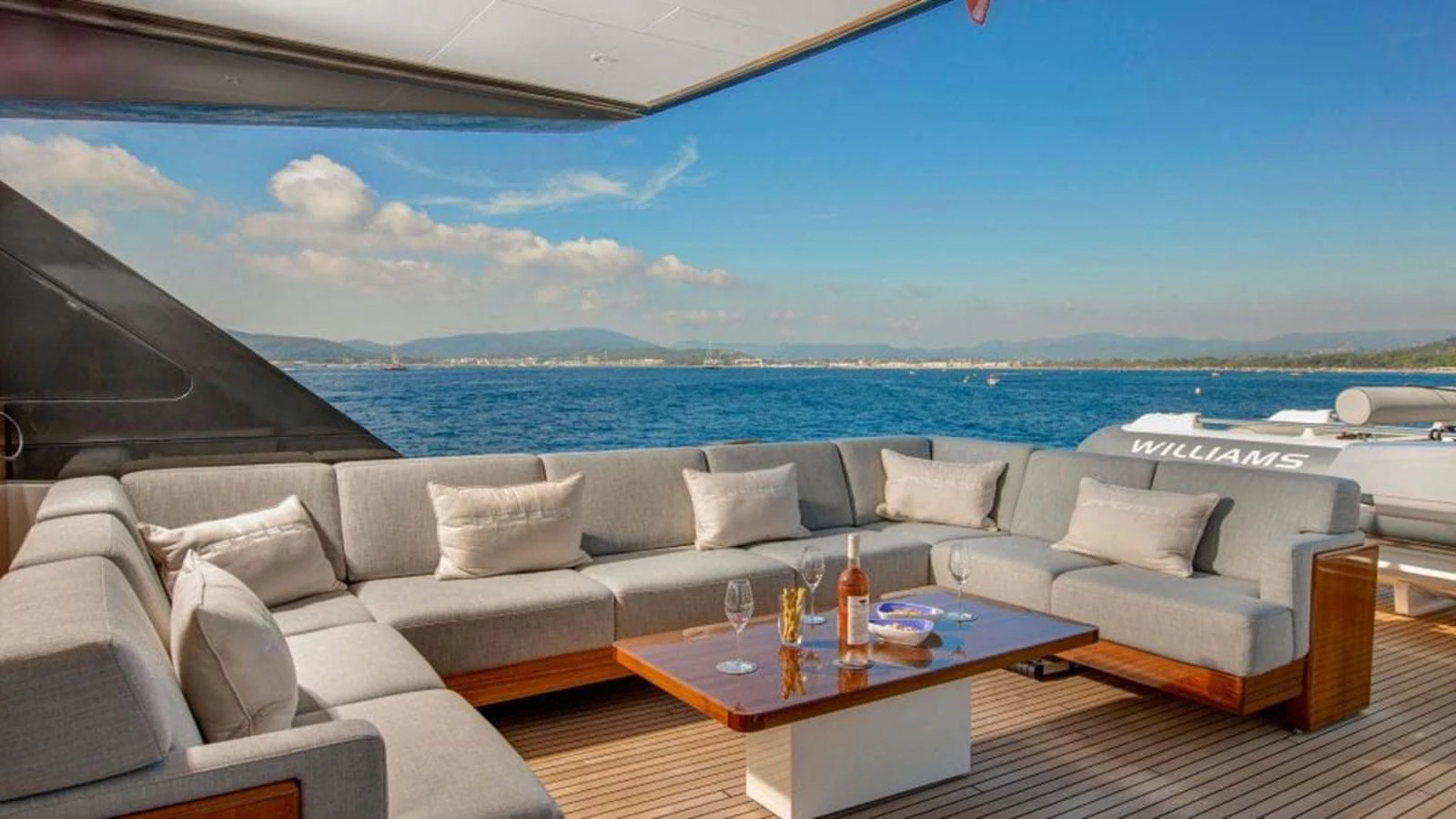 The aft deck features a spacious and luxurious seating area with a stunning ocean view. aboard JANGADA Yacht for Sale