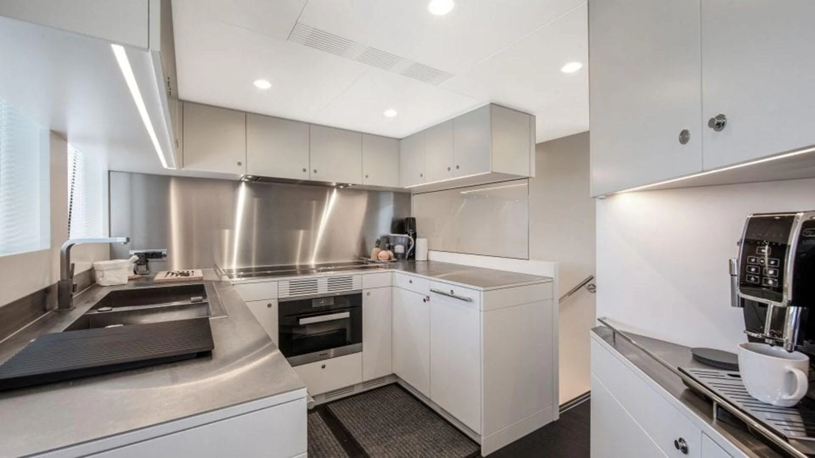The galley features modern appliances and sleek cabinetry, ideal for gourmet meal preparation. aboard JANGADA Yacht for Sale