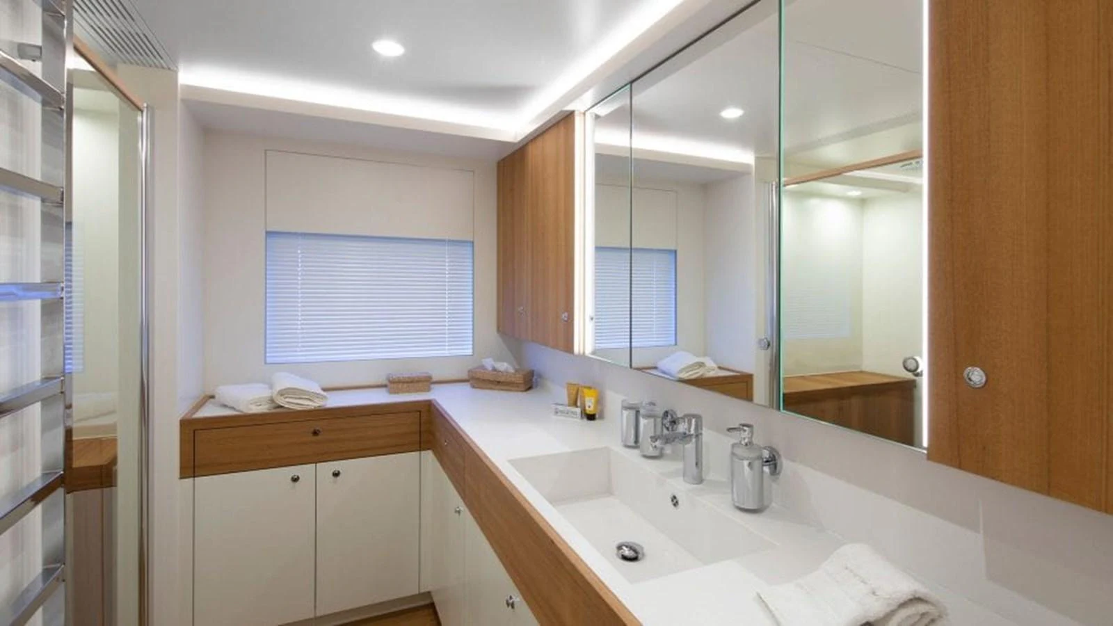 The yacht's bathroom features modern fixtures and a sleek design with ample storage space. aboard JANGADA Yacht for Sale