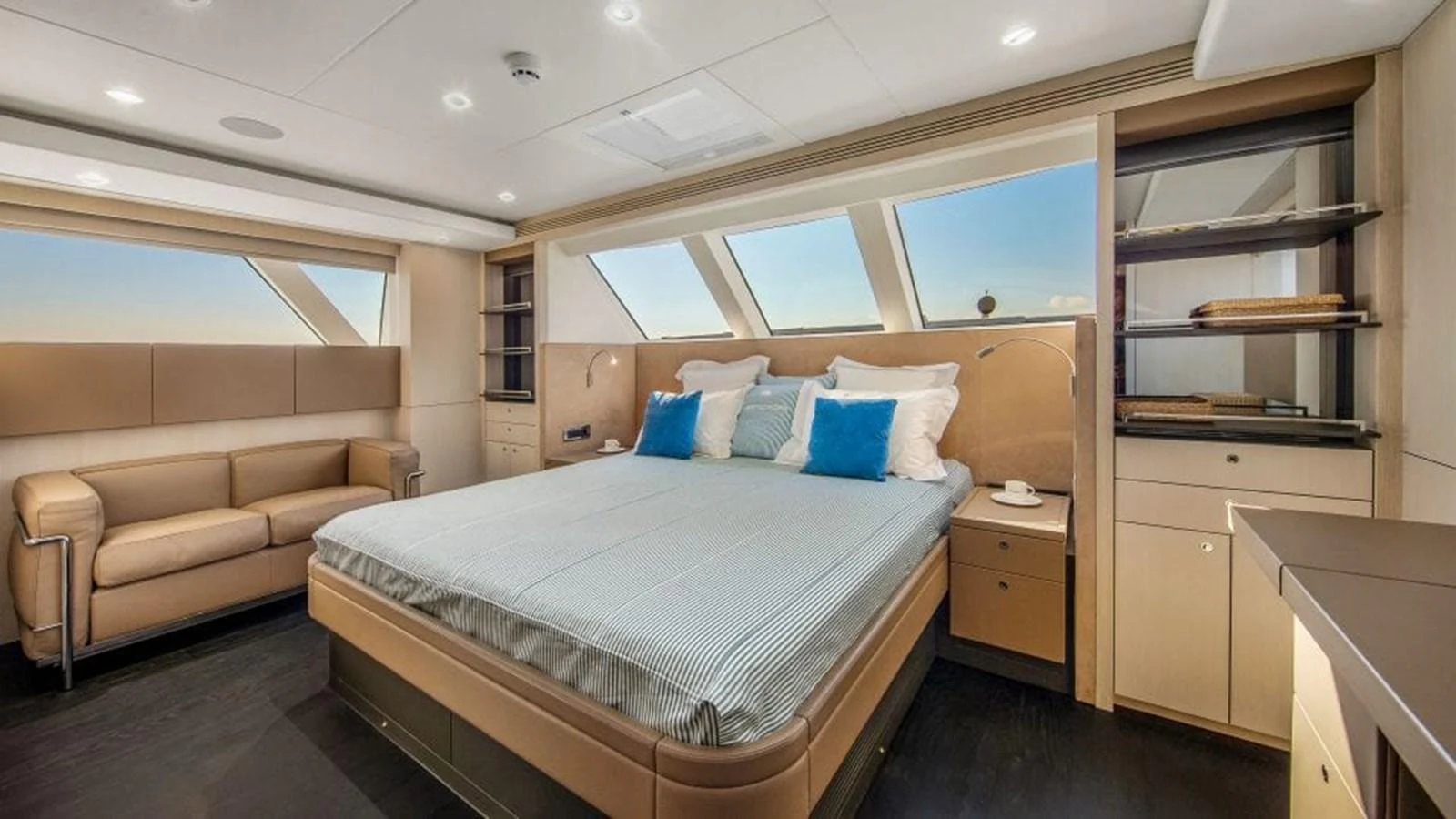 The master stateroom features a spacious bed, elegant furnishings, and ample natural light. aboard JANGADA Yacht for Sale