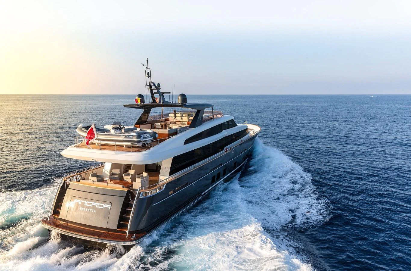 A sleek yacht cruises through open waters, showcasing its modern design and luxurious amenities. aboard JANGADA Yacht for Sale