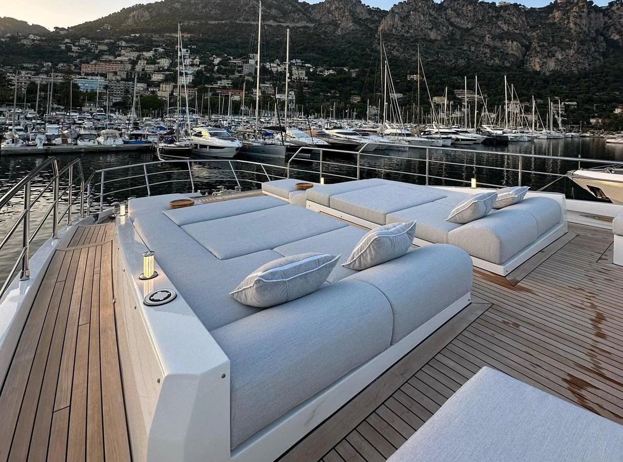 The sundeck features luxurious sunbeds with a stunning marina view. aboard G Yacht for Sale