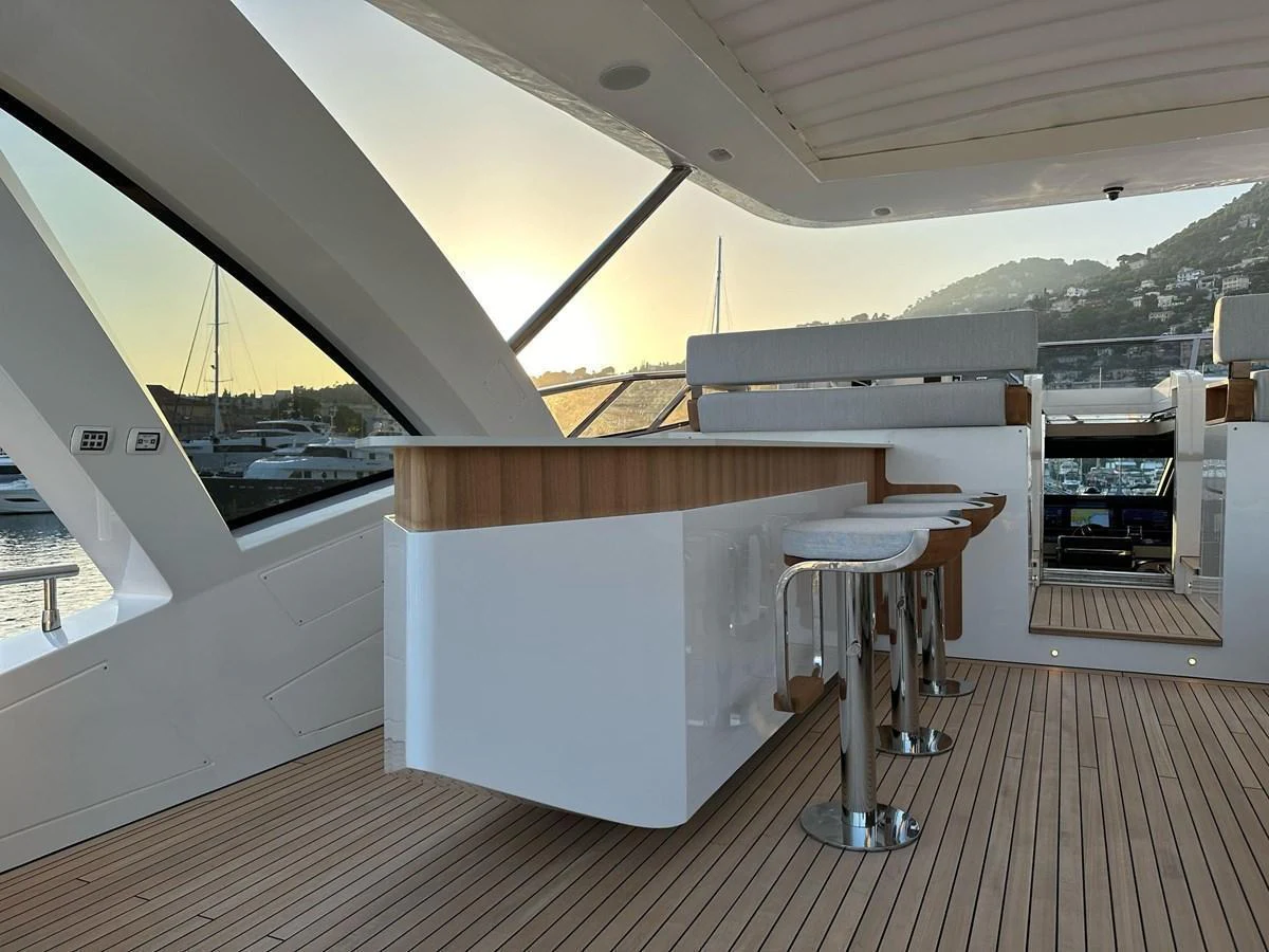 The flybridge features a sleek bar area with modern stools and panoramic views. aboard G Yacht for Sale