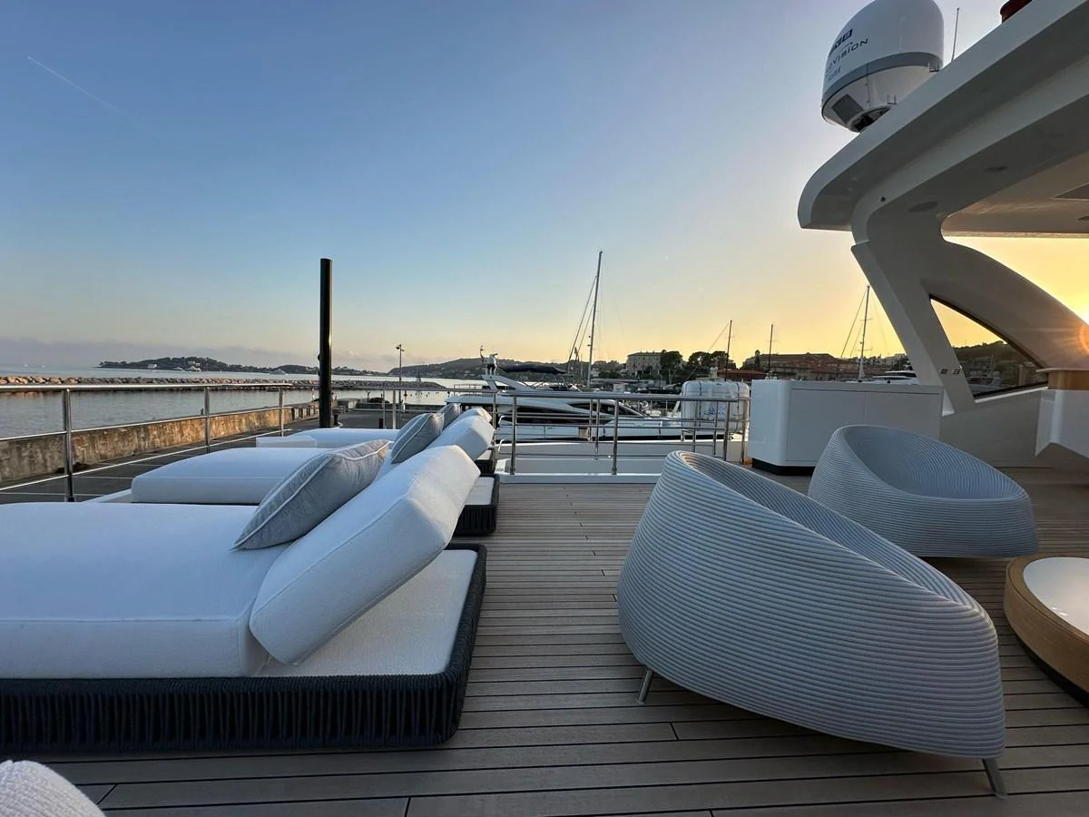 The sundeck offers a luxurious space with comfortable lounge chairs and a stunning view of the marina. aboard G Yacht for Sale