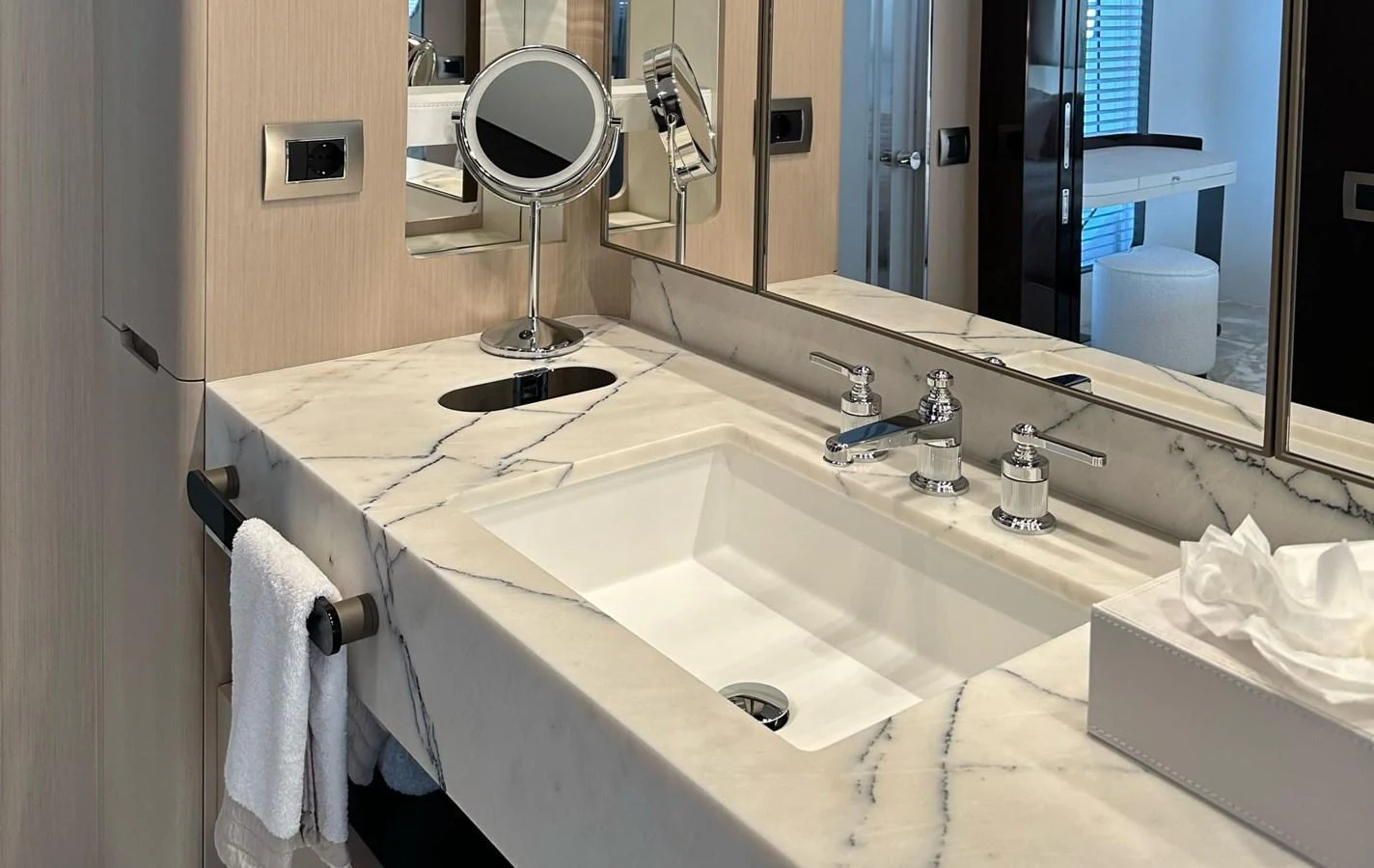 The yacht's bathroom features a luxurious marble countertop with modern fixtures. aboard G Yacht for Sale