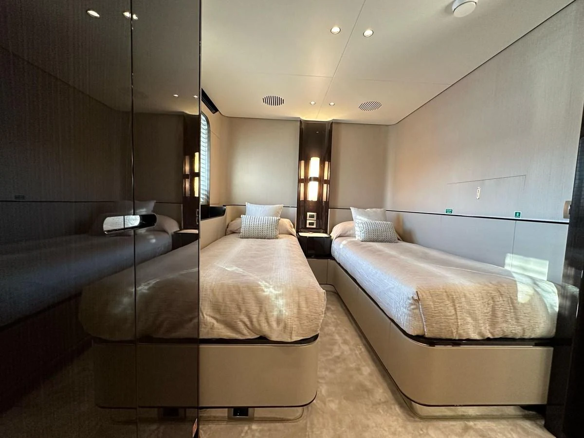 The twin stateroom offers a sleek and modern design with comfortable twin beds and elegant lighting. aboard G Yacht for Sale