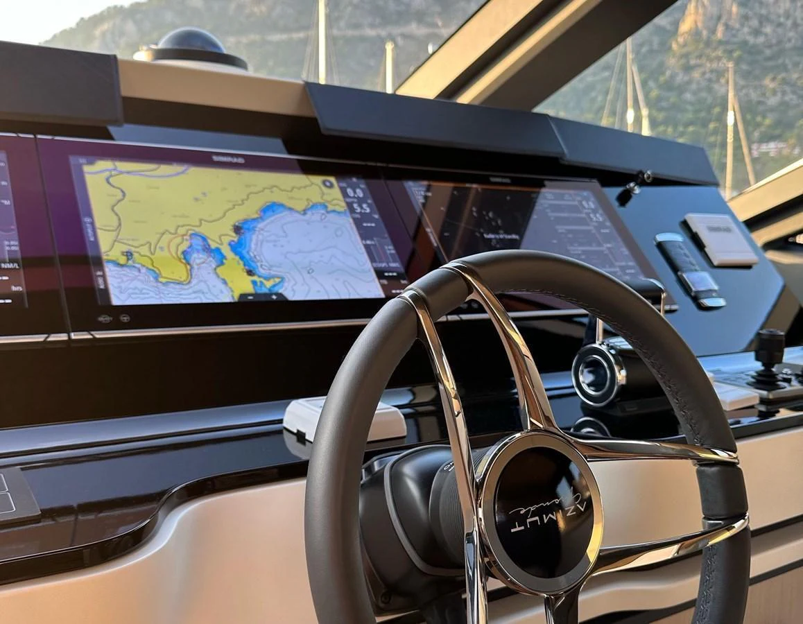 The helm station features advanced navigation systems and a sleek steering wheel. aboard G Yacht for Sale