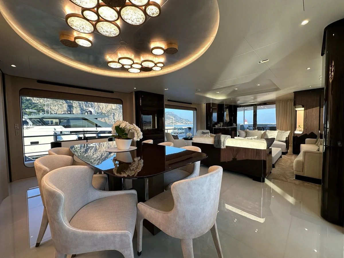 The luxurious salon features elegant seating and a sophisticated dining area with panoramic views. aboard G Yacht for Sale
