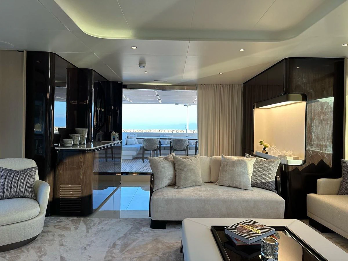 The yacht's salon features luxurious seating and elegant decor with a view of the aft deck. aboard G Yacht for Sale