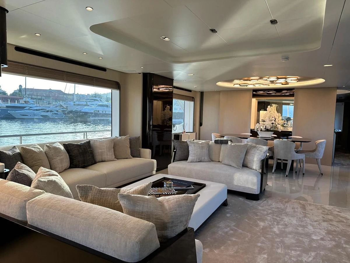 The salon offers a luxurious and spacious seating area with elegant decor and a stunning view of the marina. aboard G Yacht for Sale