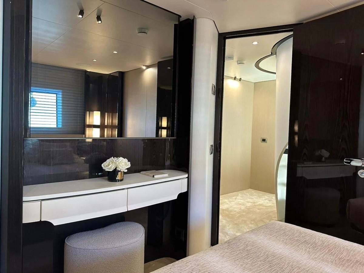 A luxurious stateroom featuring a vanity, plush seating, and elegant lighting. aboard G Yacht for Sale