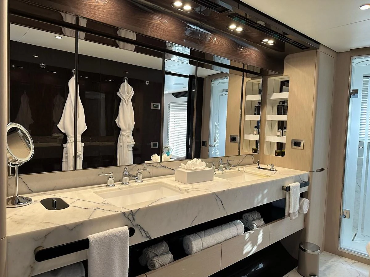 The yacht's bathroom features a luxurious double sink vanity with ample storage and elegant fixtures. aboard G Yacht for Sale