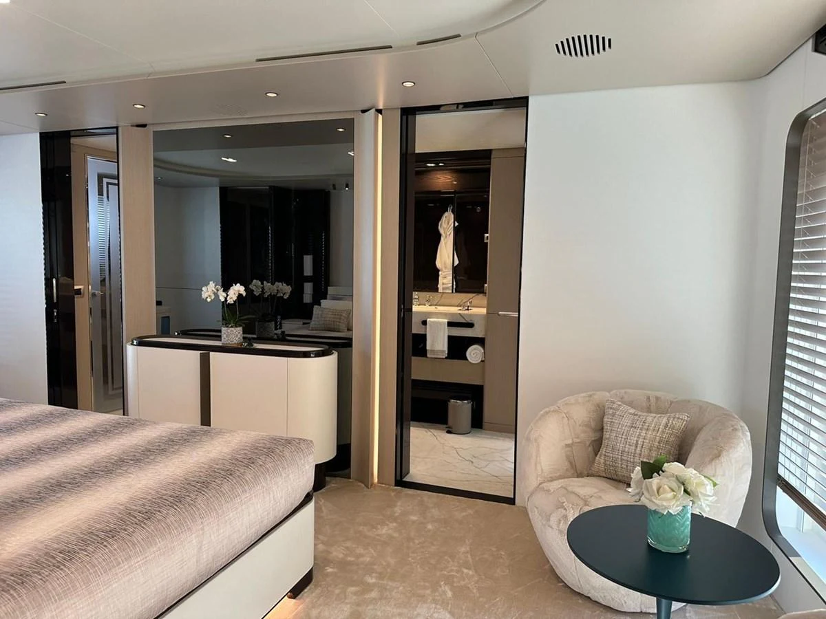 The master stateroom features a plush bed, elegant decor, and a private ensuite bathroom. aboard G Yacht for Sale