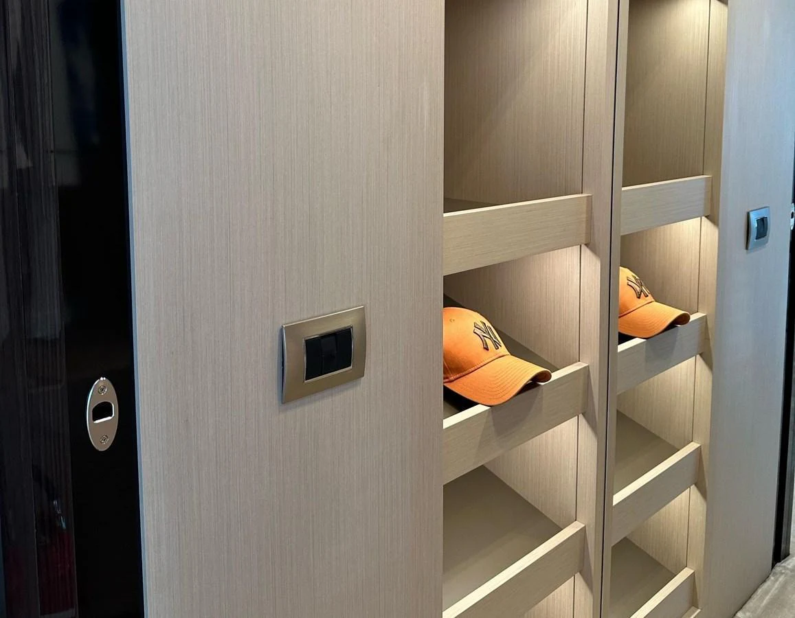 A sleek and modern storage area with built-in shelves and subtle lighting. aboard G Yacht for Sale