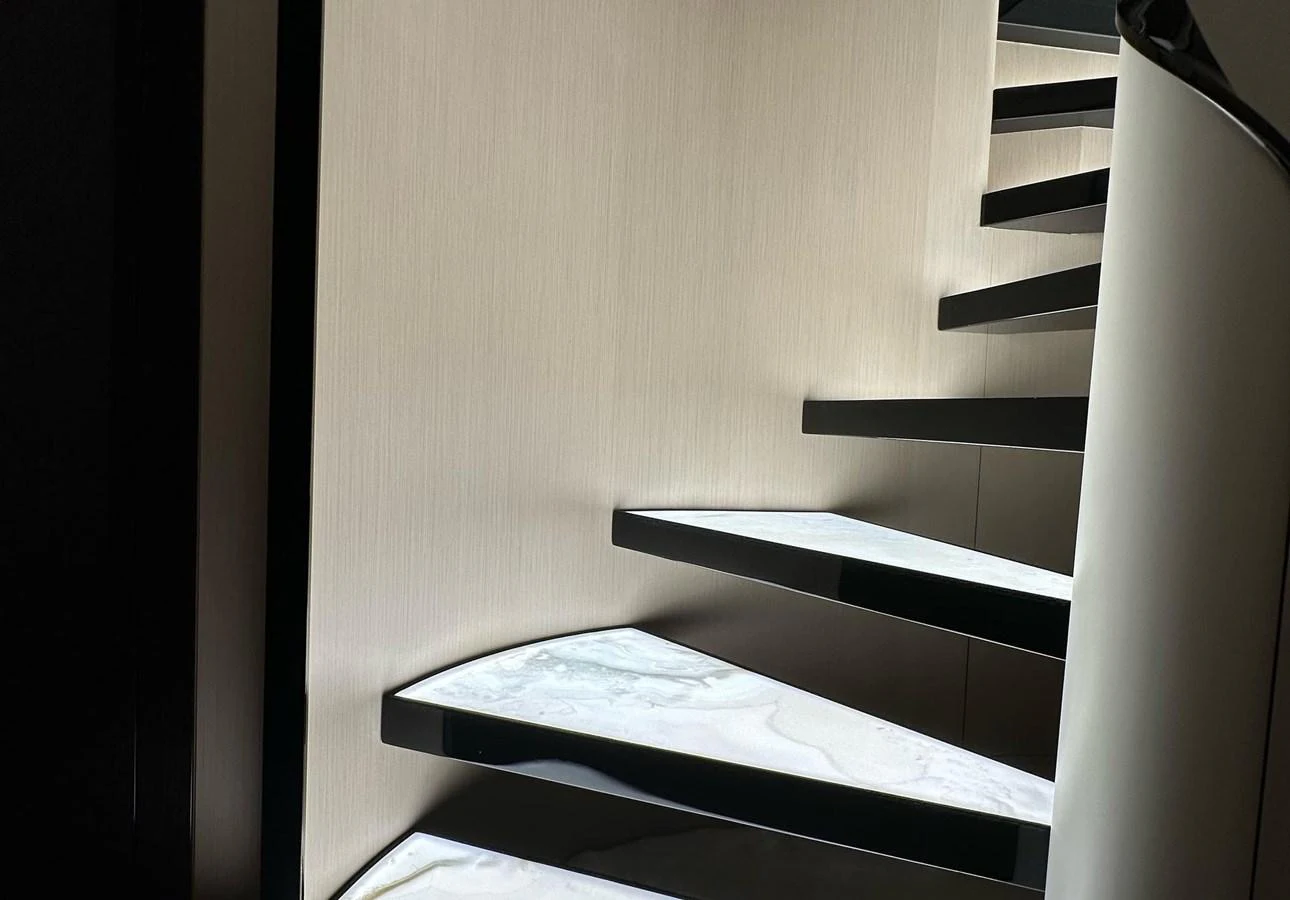 A sleek, modern staircase with illuminated steps adds a touch of elegance to the yacht's interior. aboard G Yacht for Sale