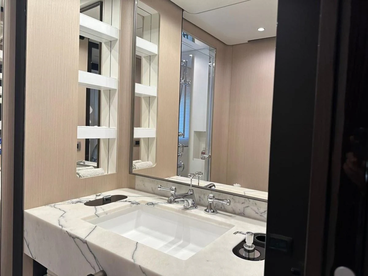 The yacht's bathroom features a luxurious marble sink and modern fixtures. aboard G Yacht for Sale