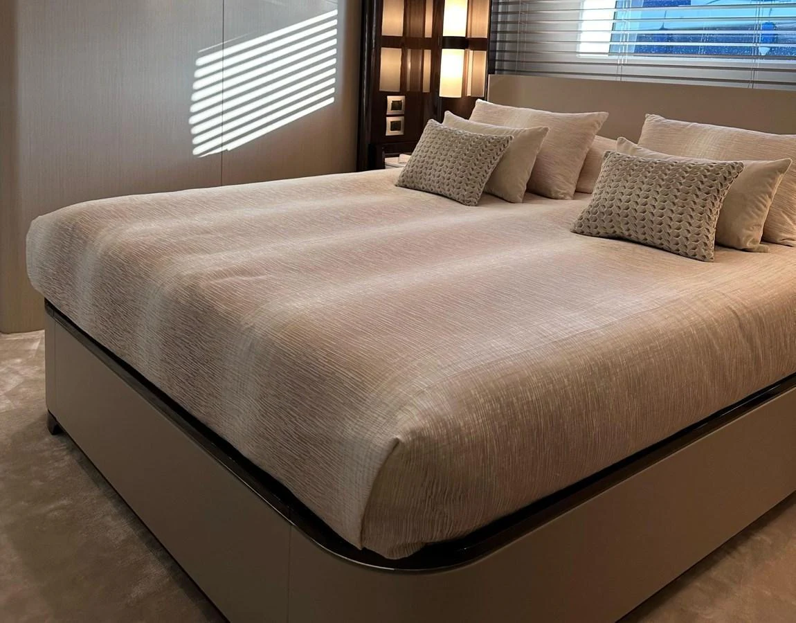 The stateroom features a plush bed with elegant bedding and soft lighting, creating a serene and luxurious atmosphere. aboard G Yacht for Sale