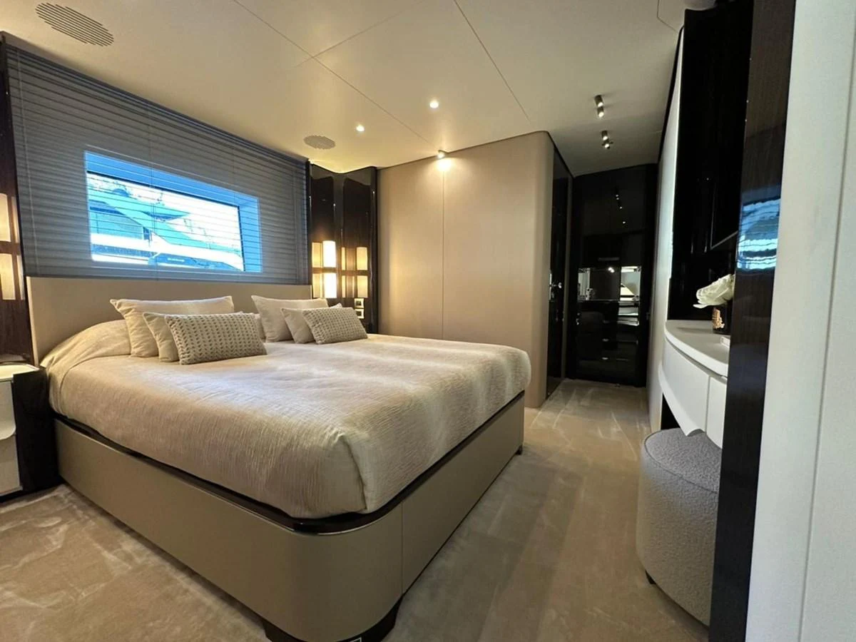 The master stateroom features a luxurious bed with elegant decor and ample natural light. aboard G Yacht for Sale