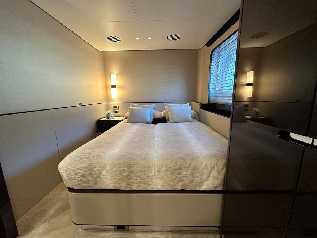A luxurious stateroom featuring a large, comfortable bed and modern lighting. aboard G Yacht for Sale