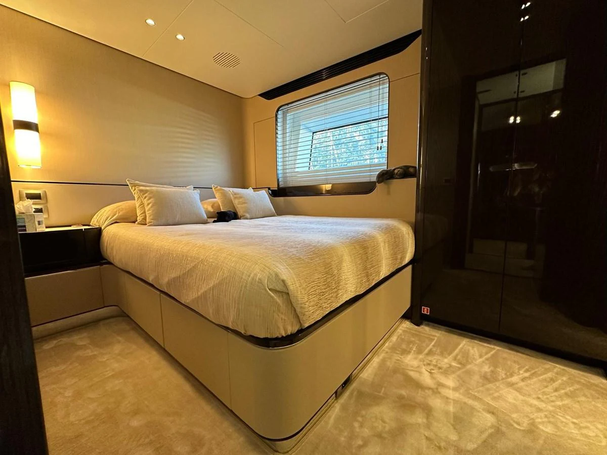 The stateroom features a plush bed with elegant bedding and modern lighting, creating a cozy and luxurious atmosphere. aboard G Yacht for Sale