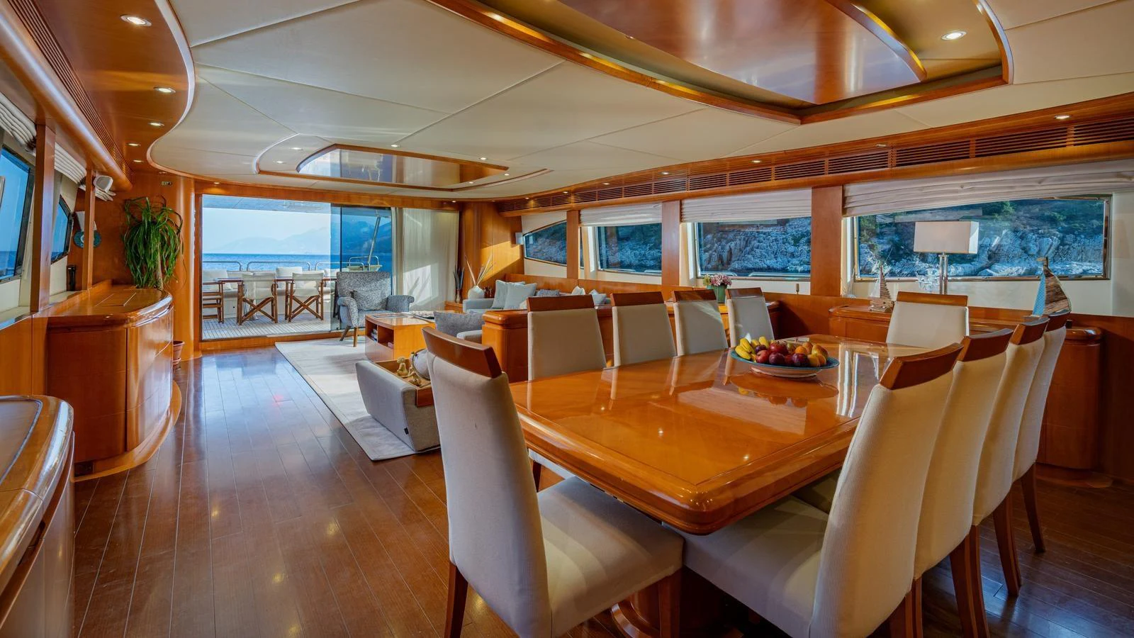 The spacious salon features elegant dining and lounging areas with panoramic views. aboard LIMION Yacht for Sale