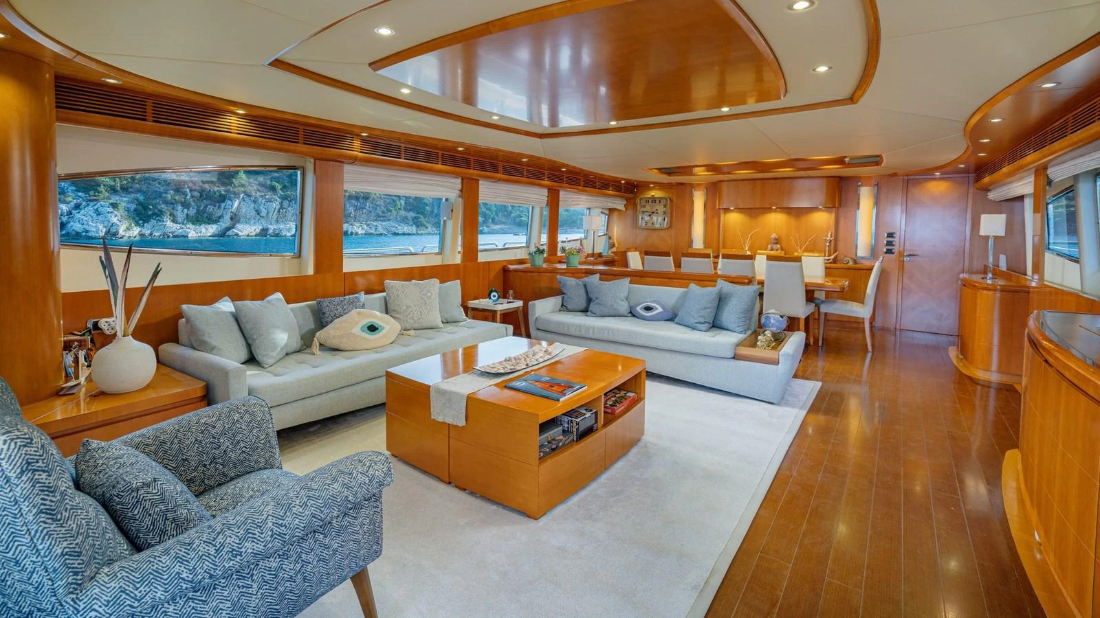 The salon features elegant wood finishes, plush seating, and large windows offering stunning views. aboard LIMION Yacht for Sale