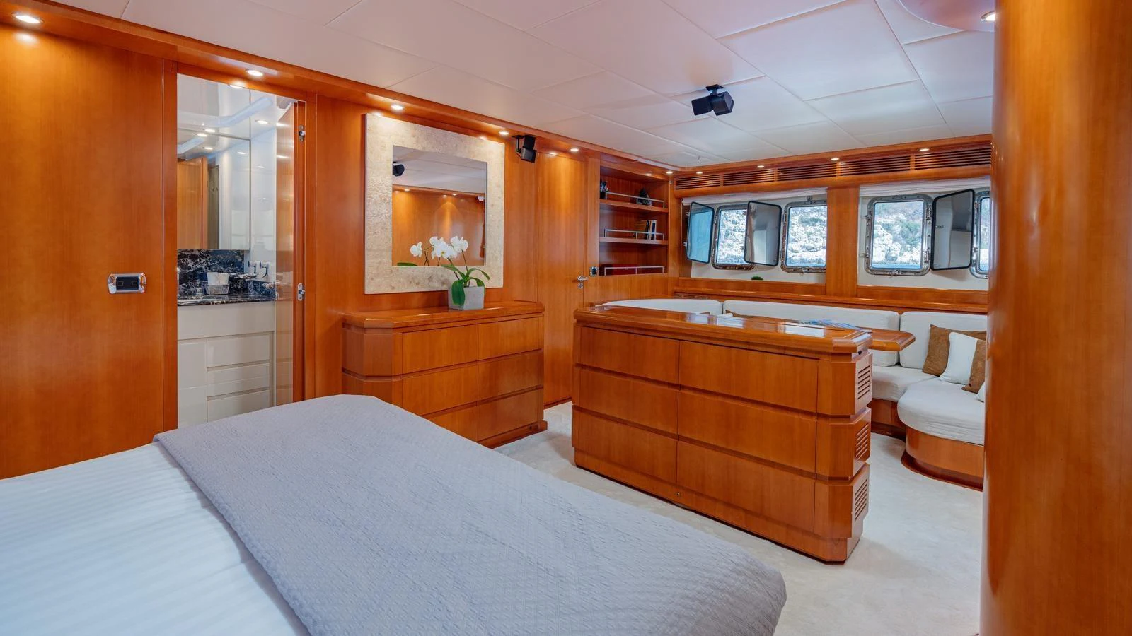 The master stateroom features elegant wood finishes and a cozy seating area. aboard LIMION Yacht for Sale