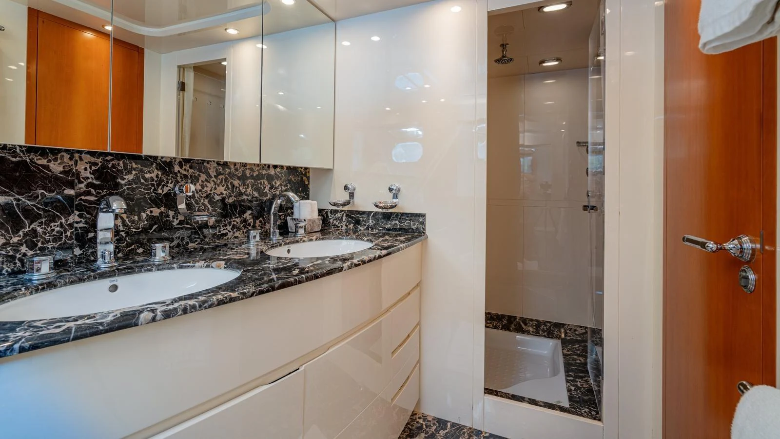 The yacht's bathroom features a luxurious design with a double sink and marble countertops. aboard LIMION Yacht for Sale