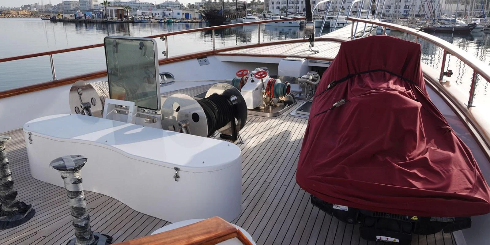 The foredeck features a covered seating area and various equipment for yacht operations. aboard AKHENATON Yacht for Sale