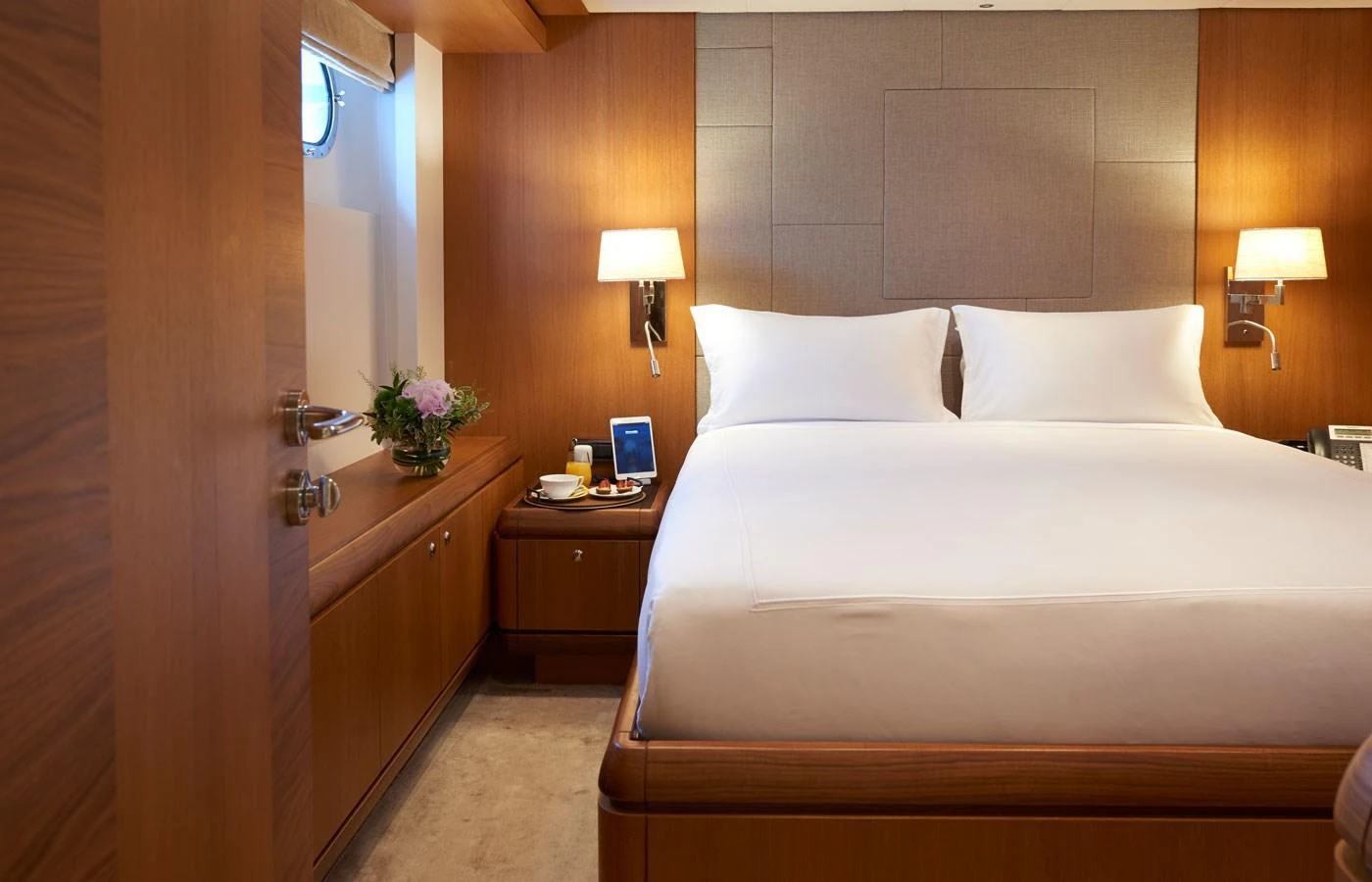 The stateroom features a cozy and elegant design with warm wooden accents and soft lighting. aboard GALENA Yacht for Sale