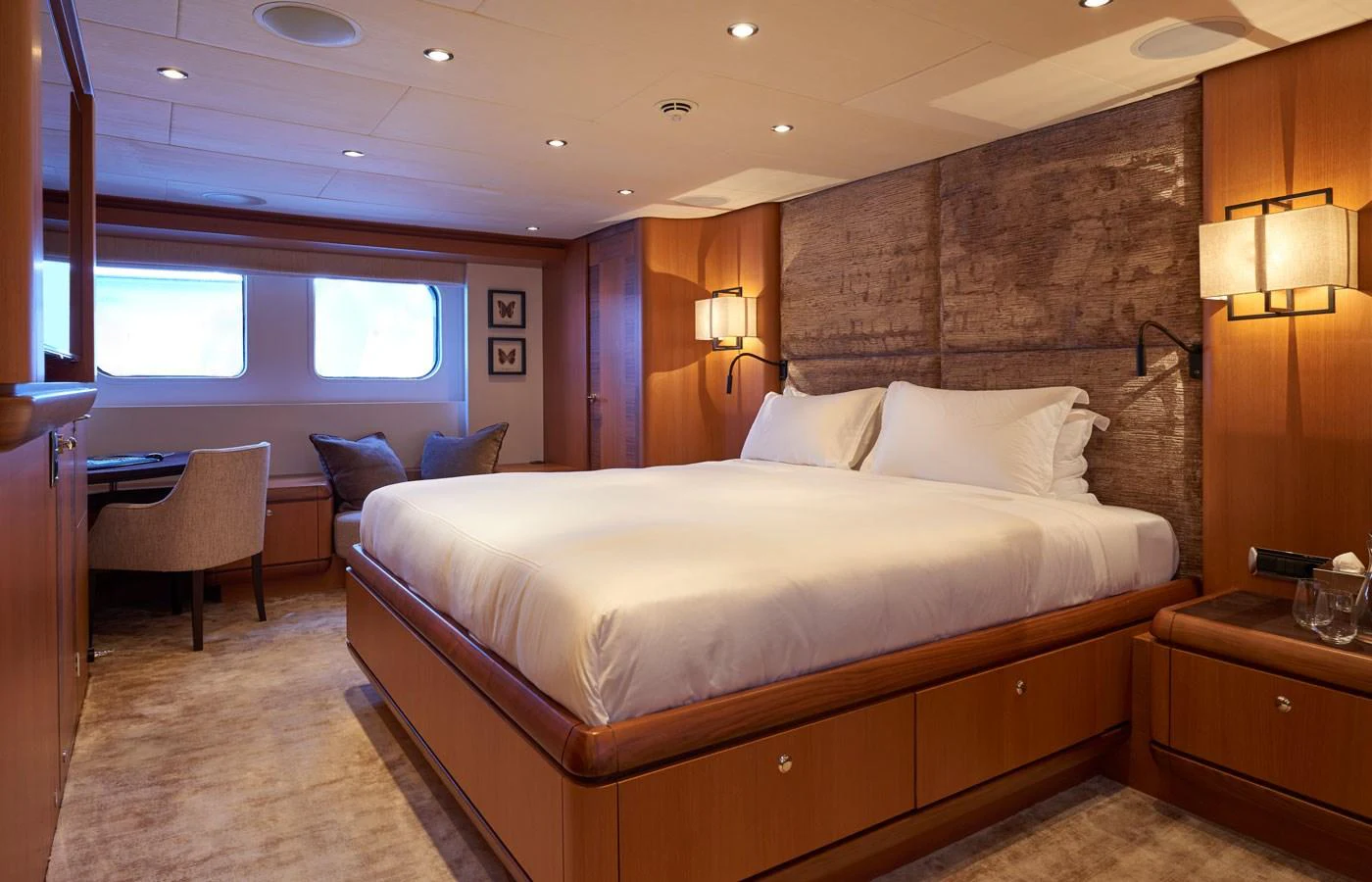 The master stateroom features a luxurious bed with elegant wooden furnishings and soft lighting. aboard GALENA Yacht for Sale