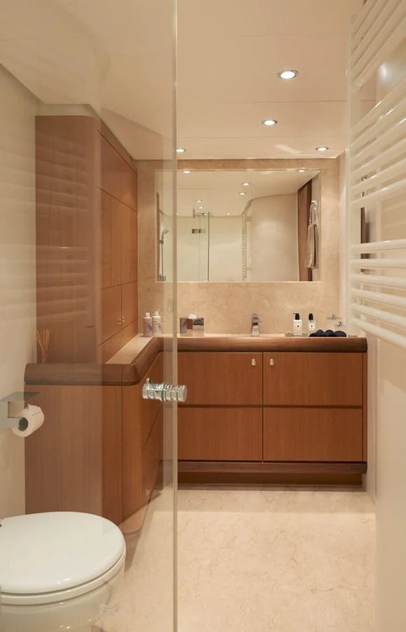 A luxurious yacht bathroom with wooden cabinetry and modern fixtures. aboard GALENA Yacht for Sale